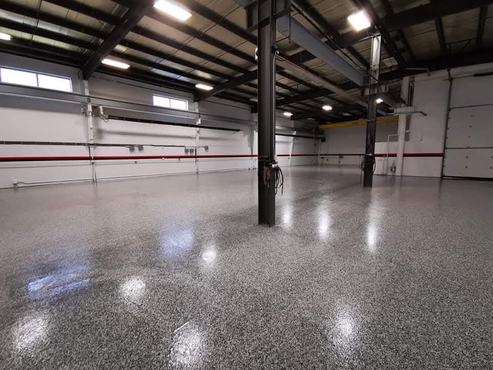Flake epoxy floor system in commercial warehouse with structural columns