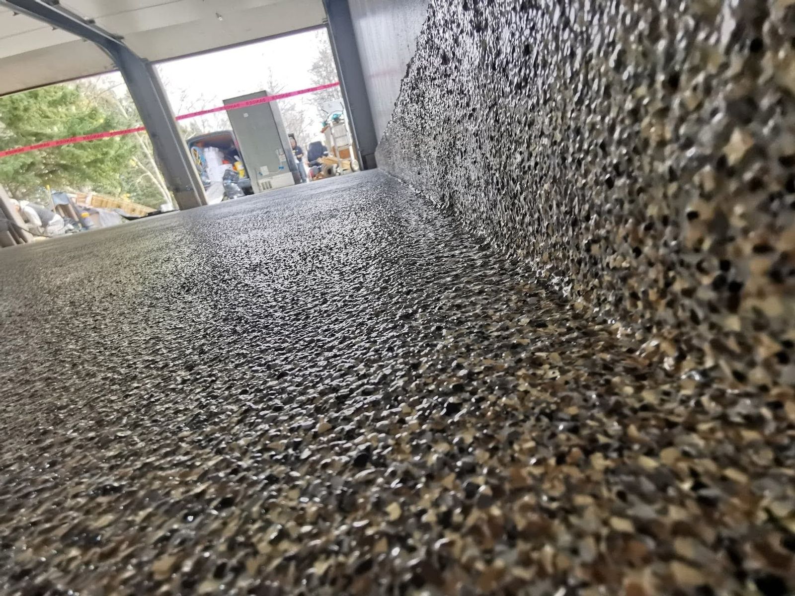 Close-up of flake epoxy floor with seamless integral cove base up the wall