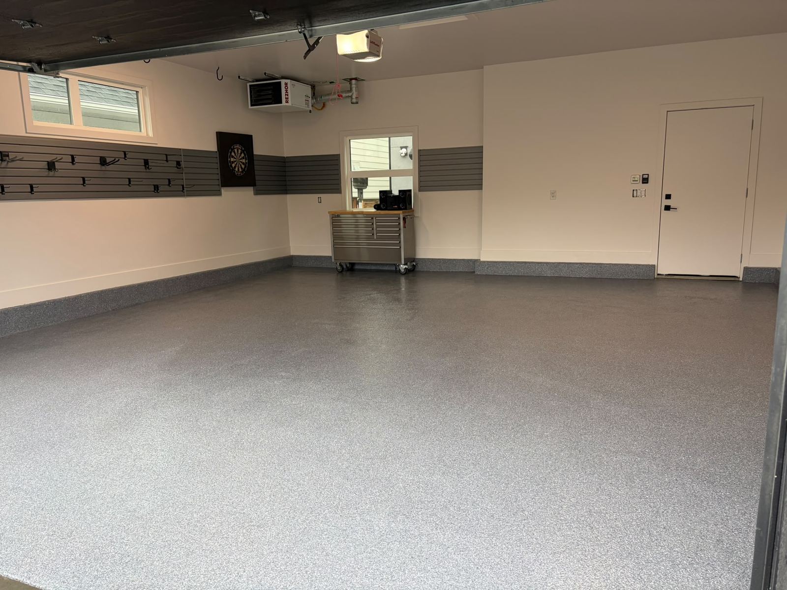 Finished residential garage with tool chest and workbench